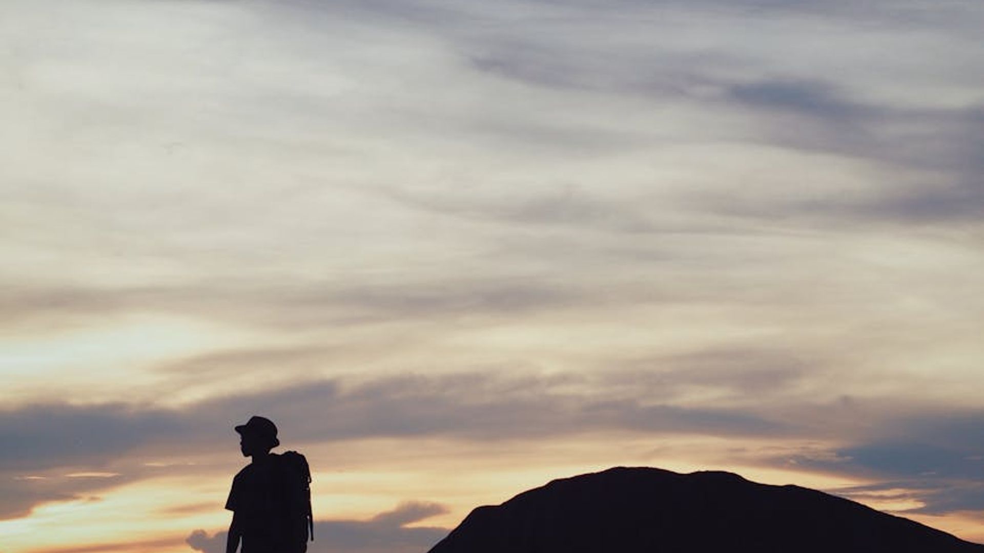 Person focusing on a distant horizon at dusk
